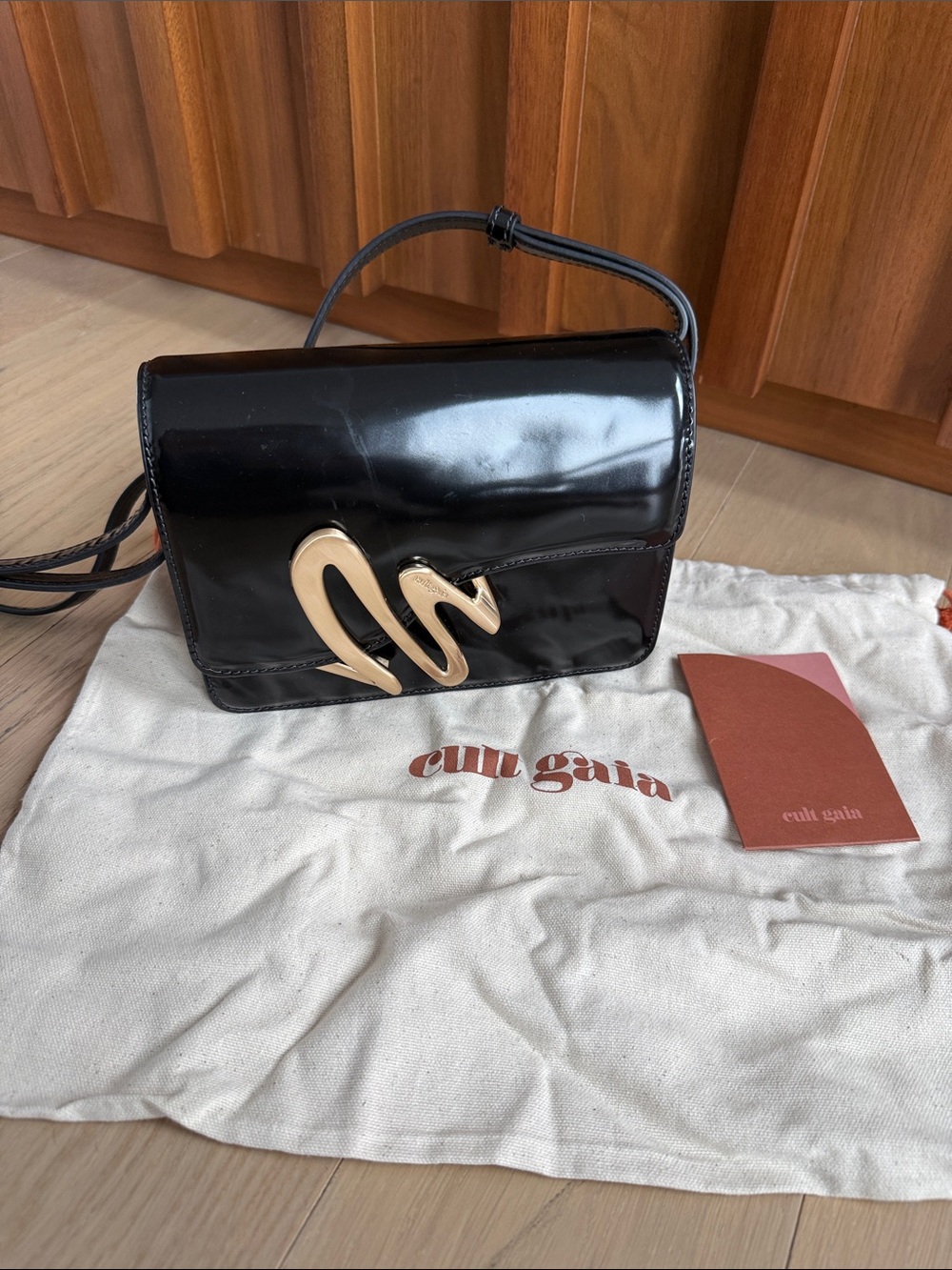 cult gaia Black Patent Mina Crossbody with Gold Sculptural Accent